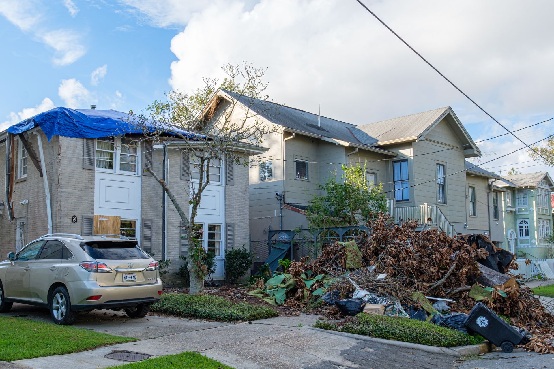 Residential property with storm damage to roof and exterior
